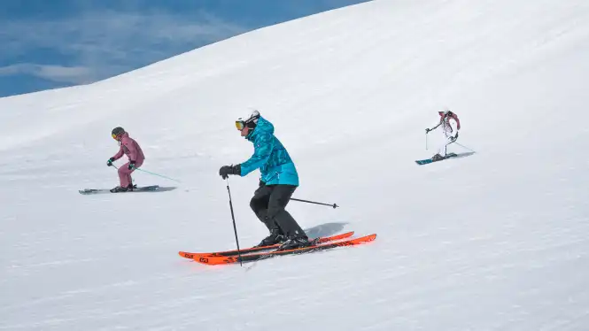 Skiers in the higher blue runs of Aime 2000