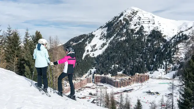 Skiers standing on the intermediate runs above Plagne Bellecote, La Plagne