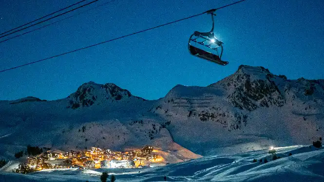 Chairlift under a moonlit sky in La Plagne