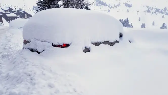 Snow-covered car in La Plagne in january