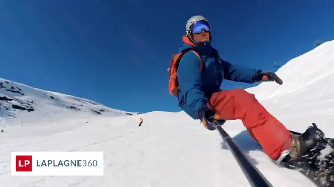Snowboarder riding a blue intermediate piste in La Plagne