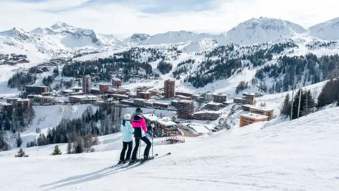 view over Plagne Centre with an intermediate skiing couple