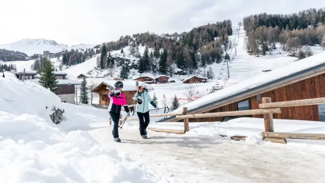 Skiers walking through La Plagne